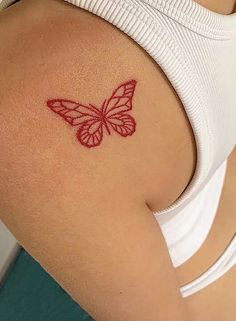 a woman with a butterfly tattoo on her shoulder