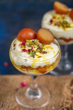 two desserts are sitting in small glasses on a table