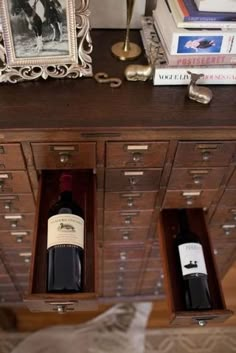 two bottles of wine sit in open drawers