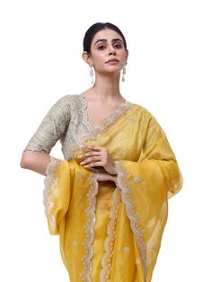 Look like a royalty in this exquisite yellow embroidered organza silk saree at weddings and special occasions. It comes with a beautiful sage green embroidered blouse. Yellow Silk Traditional Wear With Intricate Embroidery, Yellow Blouse With Resham Embroidery For Reception, Yellow Bollywood Blouse With Chikankari Embroidery, Yellow Tissue Silk Saree With Chikankari Embroidery, Yellow Chikankari Embroidery Pre-draped Saree For Wedding, Yellow Chikankari Embroidery Saree For Reception, Pista Green Chanderi Blouse For Wedding, Yellow Saree With Intricate Embroidery For Diwali, Yellow Chikankari Embroidered Dupatta For Reception