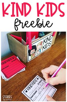 a kid's hand writing on a piece of paper with the words kind kids freebie