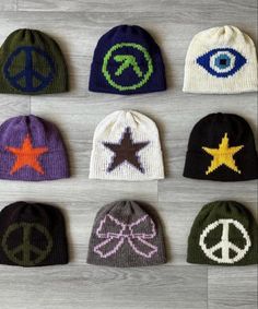 six knit beanies with different symbols on them