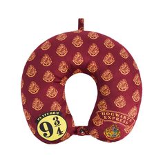 the harry potter travel pillow is red and gold with hogwart's crests on it