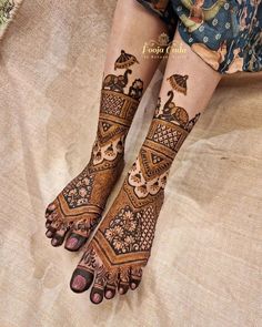 the legs and feet of a woman with henna tattoos