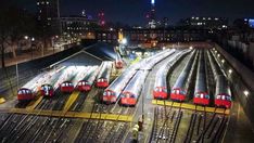 there are many trains that are on the tracks at this train station in the city