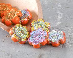 some oranges are laying on the ground next to each other and one is painted like flowers