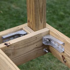 a wooden structure with metal brackets on it