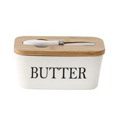 a wooden cutting board with a knife in it and the word butter written on it