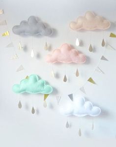 there are many clouds and raindrops hanging on the wall