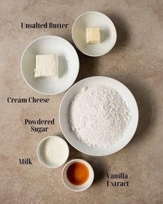 ingredients to make cheese cake laid out on top of each other, including butter, cream and powdered sugar