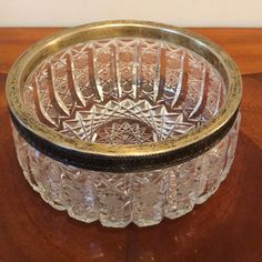 a clear glass bowl sitting on top of a wooden table