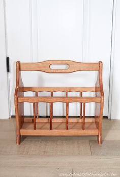 a wooden bench sitting on top of a hard wood floor