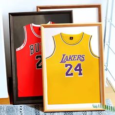 two framed basketball jerseys sitting next to each other