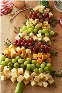 a christmas tree made out of cheese and grapes