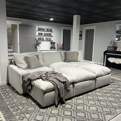 a living room with a couch, rug and piano in it's center area