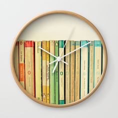 a clock made out of books on a white wall