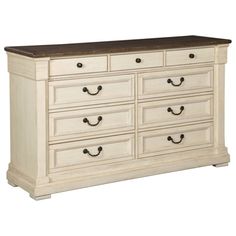 a large white dresser with drawers and wooden top