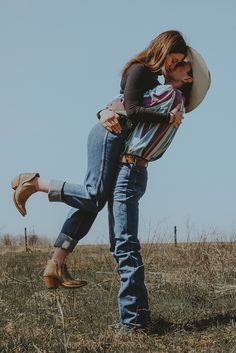 a man holding a woman on his back in a field