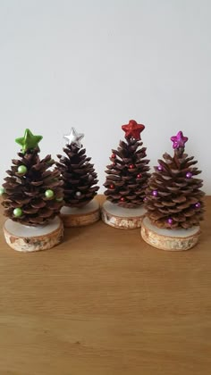 three small pine cones with decorations on them