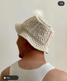 a man wearing a white crochet hat with no brimming on his head