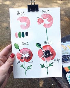 a hand holding up a piece of paper with watercolor flowers on it and the words step 1, step 2, step 3