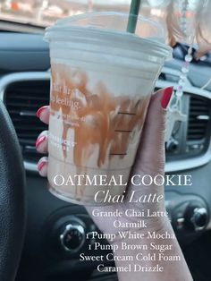 a person holding up a drink in their hand with the words, oatmeal cookie chai latte