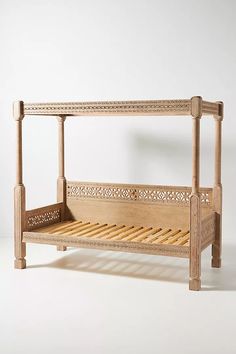 a wooden bed frame sitting on top of a white floor