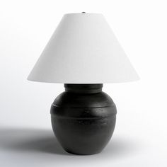 a black table lamp with a white shade on the top and bottom part of it