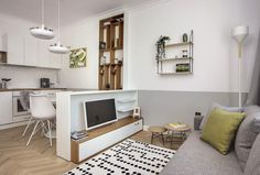 a living room filled with furniture and a flat screen tv on top of a wooden shelf