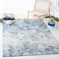 a blue and white area rug in a living room