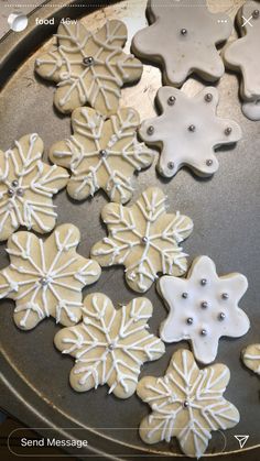 there are many snowflake cookies on the pan