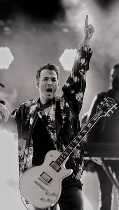 a man with an electric guitar on stage