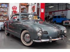 an old car is parked in a garage