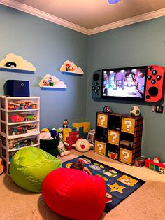 a child's playroom with toys and games on the wall, including bean bag chairs