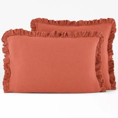 two orange pillows with ruffled edges