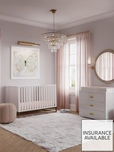 a baby's room with pink walls, white furniture and a chandelier