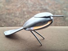 a small metal insect sitting on top of a table