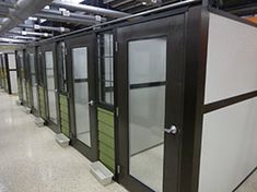 several black and white glass doors in a room with tile flooring on the ground