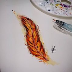 a drawing of a colorful feather on a white paper next to a marker and paintbrush