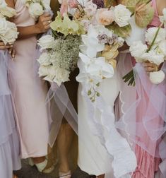 three bridesmaids holding bouquets in their hands