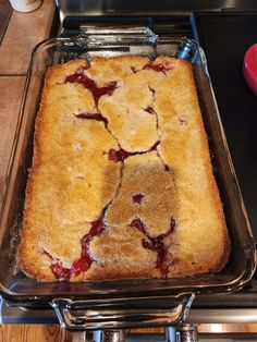 a cake in a pan on top of a stove with the toppings removed from it