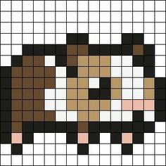 a cross stitch pattern with a dog's face in the center and brown, white, and black squares around it