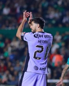 a soccer player with his hands in the air