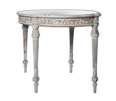 an ornately decorated table with glass top