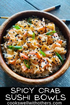 this spicy crab sushi bowl is made with rice, carrots and sesame seeds