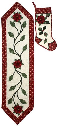 two christmas stockings with red flowers and green leaves on white fabric, one is hanging from the wall