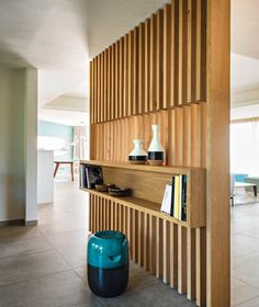 the interior of a house with wood paneling and blue stools in front of it