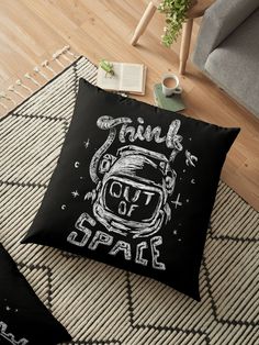 a black and white floor pillow with the words think out of space on it