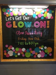 a sign advertising glow on in front of a window that says, let's get our glow on