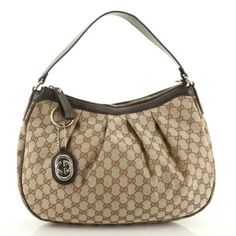 Gucci Sukey Medium Brown Gg Canvas Hobo Bag Dark Brown Leather Trim In Great Condition / No Flaws Handles: Single Flat Leather Shoulder Strap Single Zip Closure Interior Lining: Fine Textile Lining Cream Height: 10.5 In. Length: 14.5 In. Width: 4 In. Handle Drop: 7 In. Included: Authenticity Card And Gucci Dust Bag Free Shipping And Eligible For Poshmark Authentication! Canvas Hobo Bag, Bag Dark, Brown Canvas, Dark Brown Leather, Medium Brown, Free Bag, Hobo Bag, Louis Vuitton Damier, Leather Trims